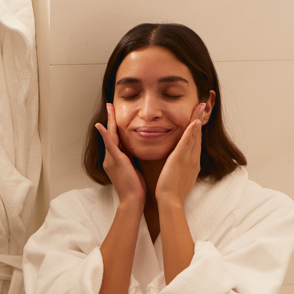 Applying Kleem Organics Hyaluronic Acid Serum to skin, daily skincare ritual for hydration and plump skin