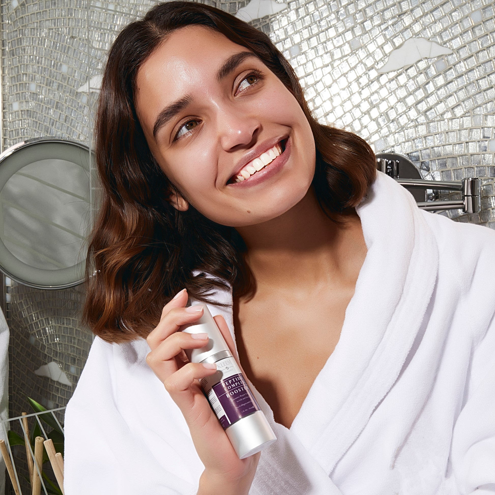 Applying Kleem Peptide Complex Booster texture – hydrating and plumping skincare routine for dull, dehydrated skin with fine lines and wrinkles, loss of firmness and elasticity