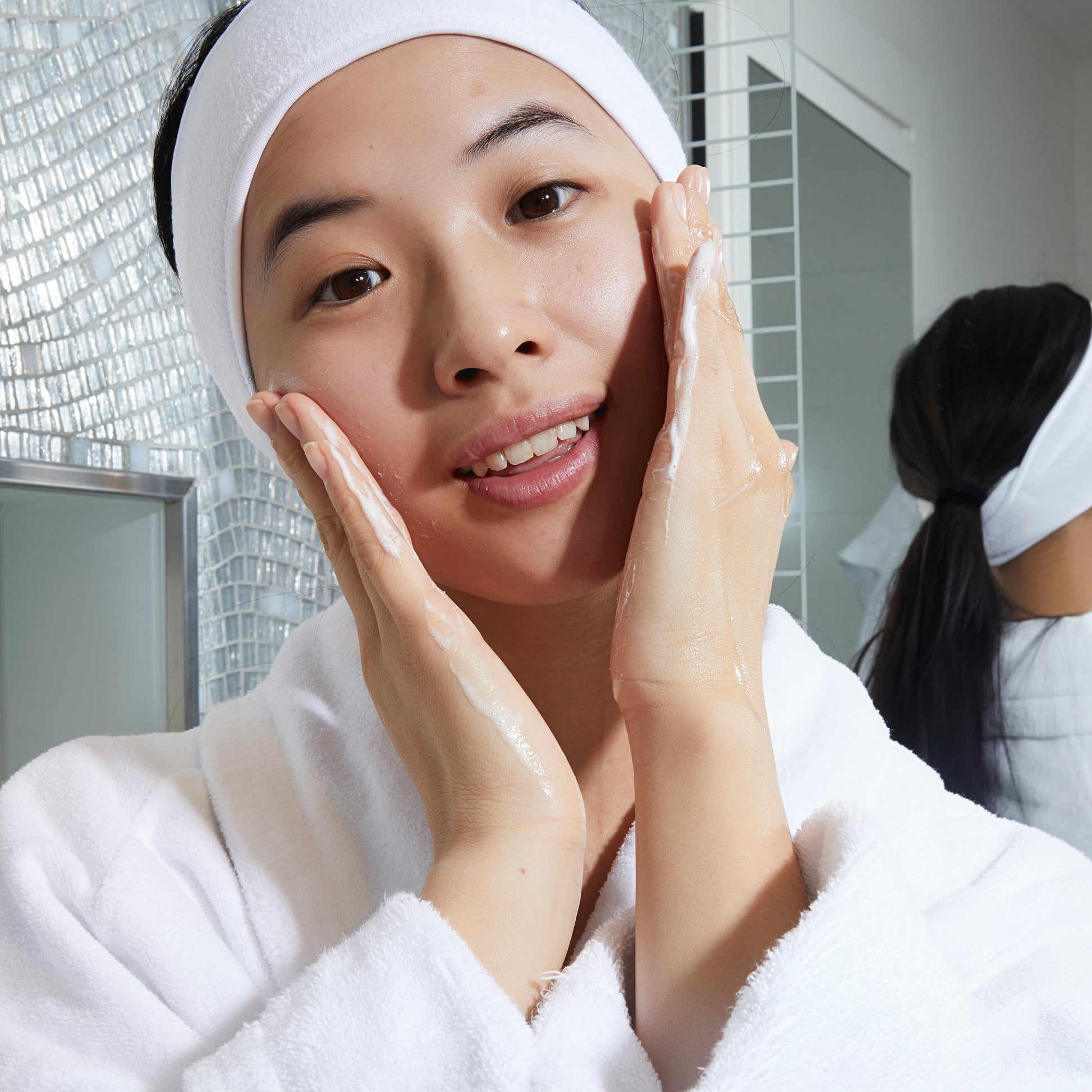 Applying Kleem Vitamin C Face Cleanser to skin, daily skincare ritual to cleanse, hydrate, leave skin soft and radiant
